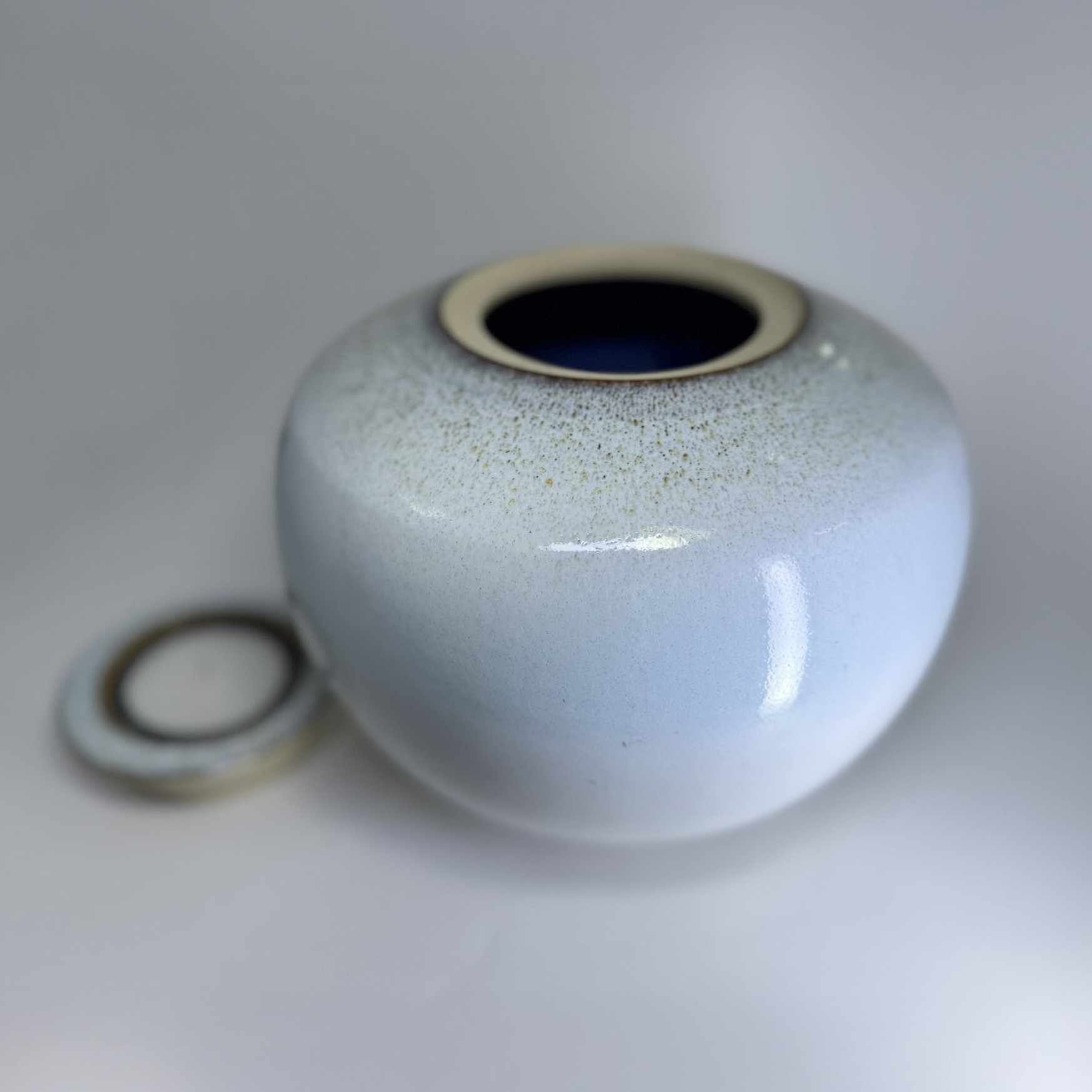 Aurora medium sized Cremation Urn Aurora cremation urn showing secure lid opening and elegant round ceramic design