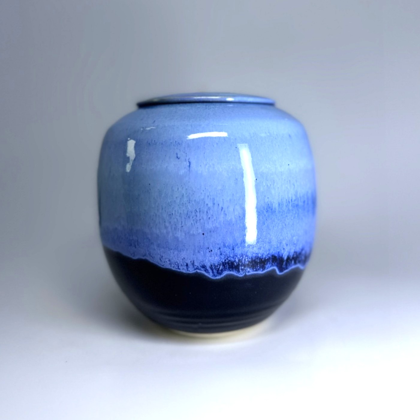 Blue Moon ceramic cremation urn with periwinkle blue glaze and black base accent