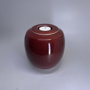 Ember small ceramic cremation urn with warm rust red glaze and integrated tealight holder