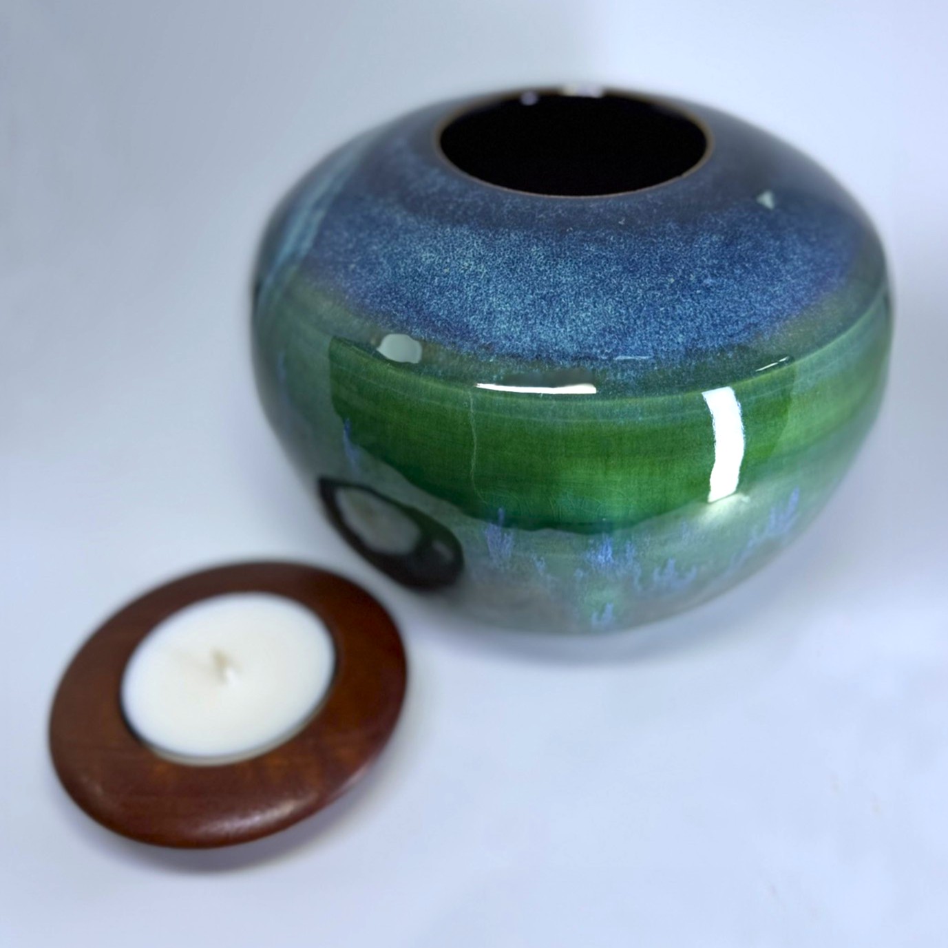 Handmade ceramic urn with removable wooden candle holder lid shown separately
