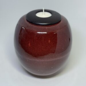 Flame ceramic cremation urn with deep red burgundy glaze and black tealight candle holder