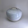 Ivory ceramic cremation urn with soft white speckled glaze and tealight candle holder