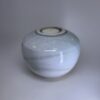 Medium ceramic memorial urn in pale ivory white with subtle textured glaze finish