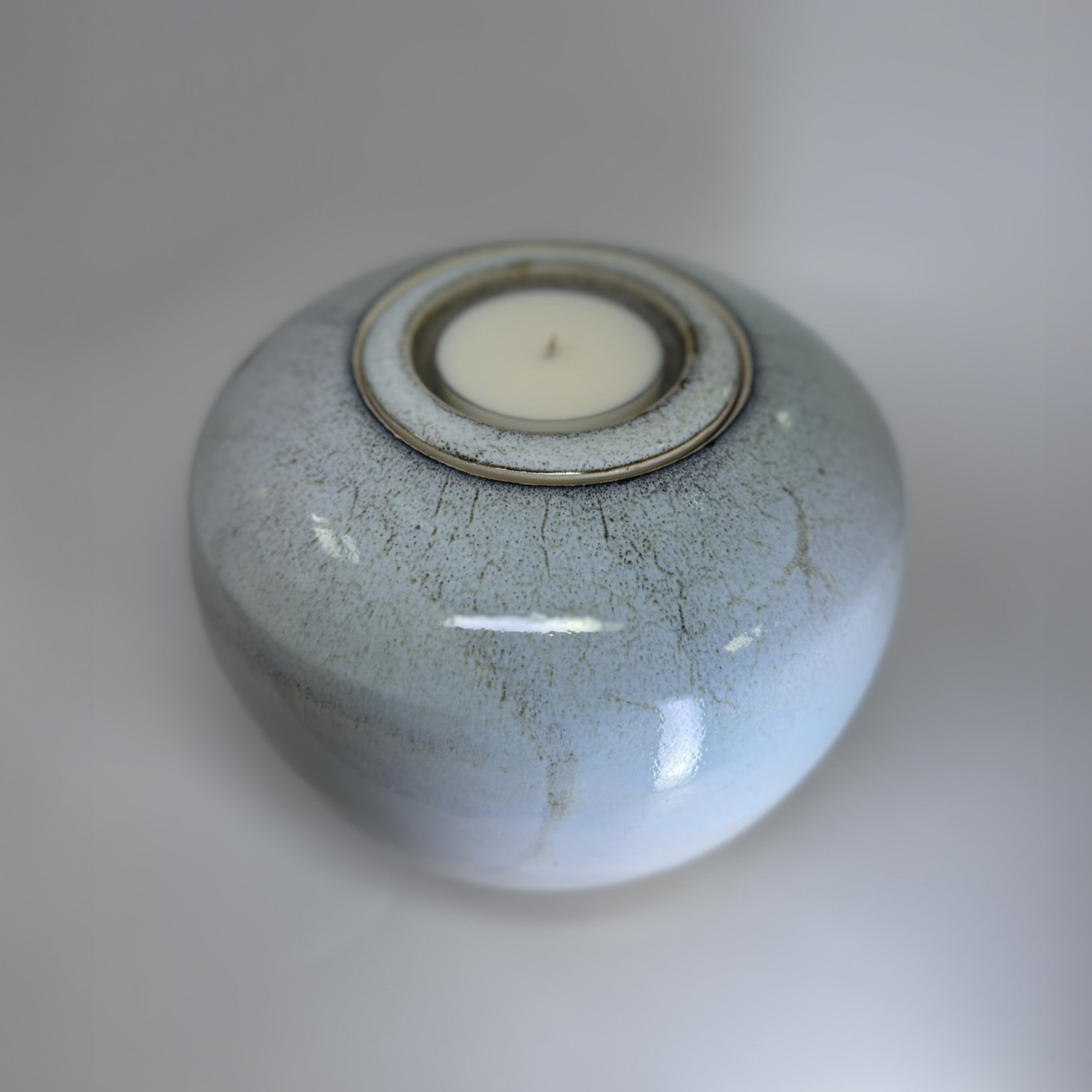 Ivory 2200ml cremation urn top view showing delicate speckled glaze detail and candle holder