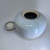Handmade ceramic urn with removable candle holder lid shown separately in ivory glaze