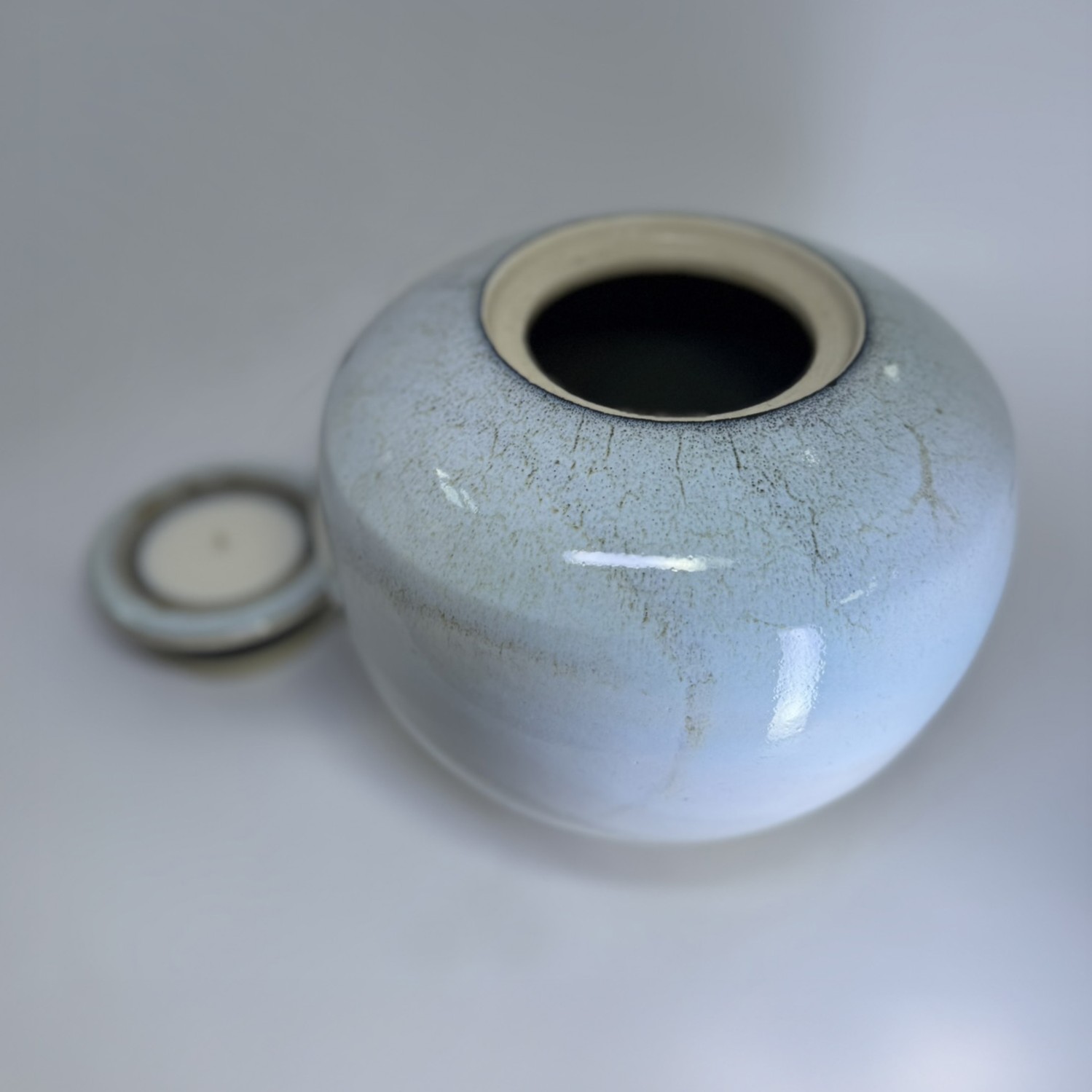 Handmade ceramic urn with removable candle holder lid shown separately in ivory glaze