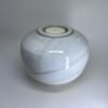 Ivory white ceramic cremation urn with natural glaze variations and glossy finish