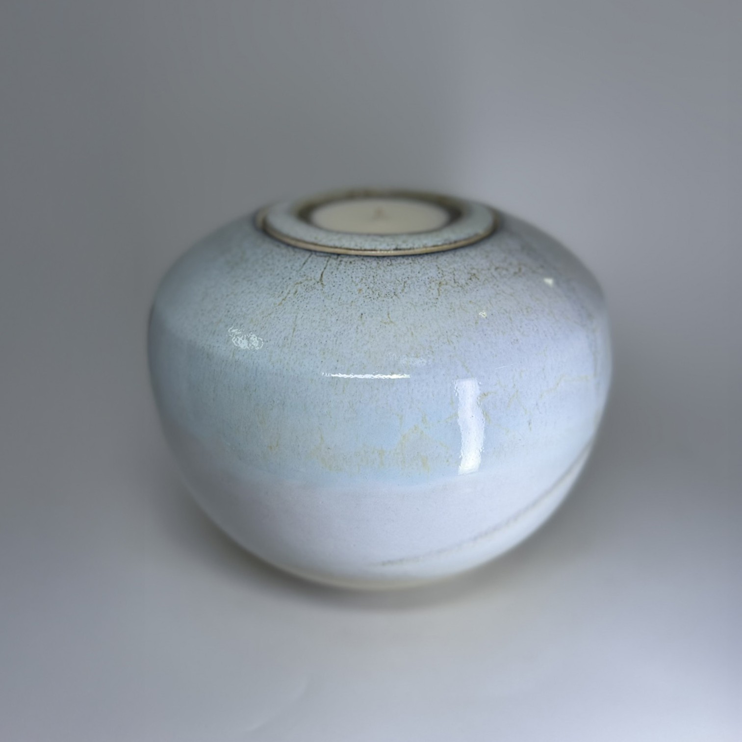 Medium memorial urn in soft ivory showing smooth rounded form and subtle glaze texture