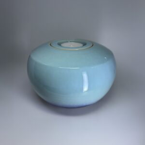 Oasis ceramic cremation urn with soft turquoise glaze and integrated tealight candle holder