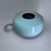 Handmade ceramic urn with removable turquoise candle holder lid shown separately