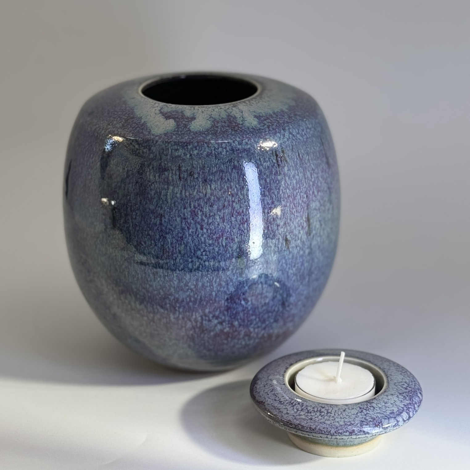 Handmade ceramic memorial urn with removable candle holder lid in purple rain glaze