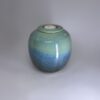 Handmade small cremation urn in ocean-inspired teal and blue gradient glaze