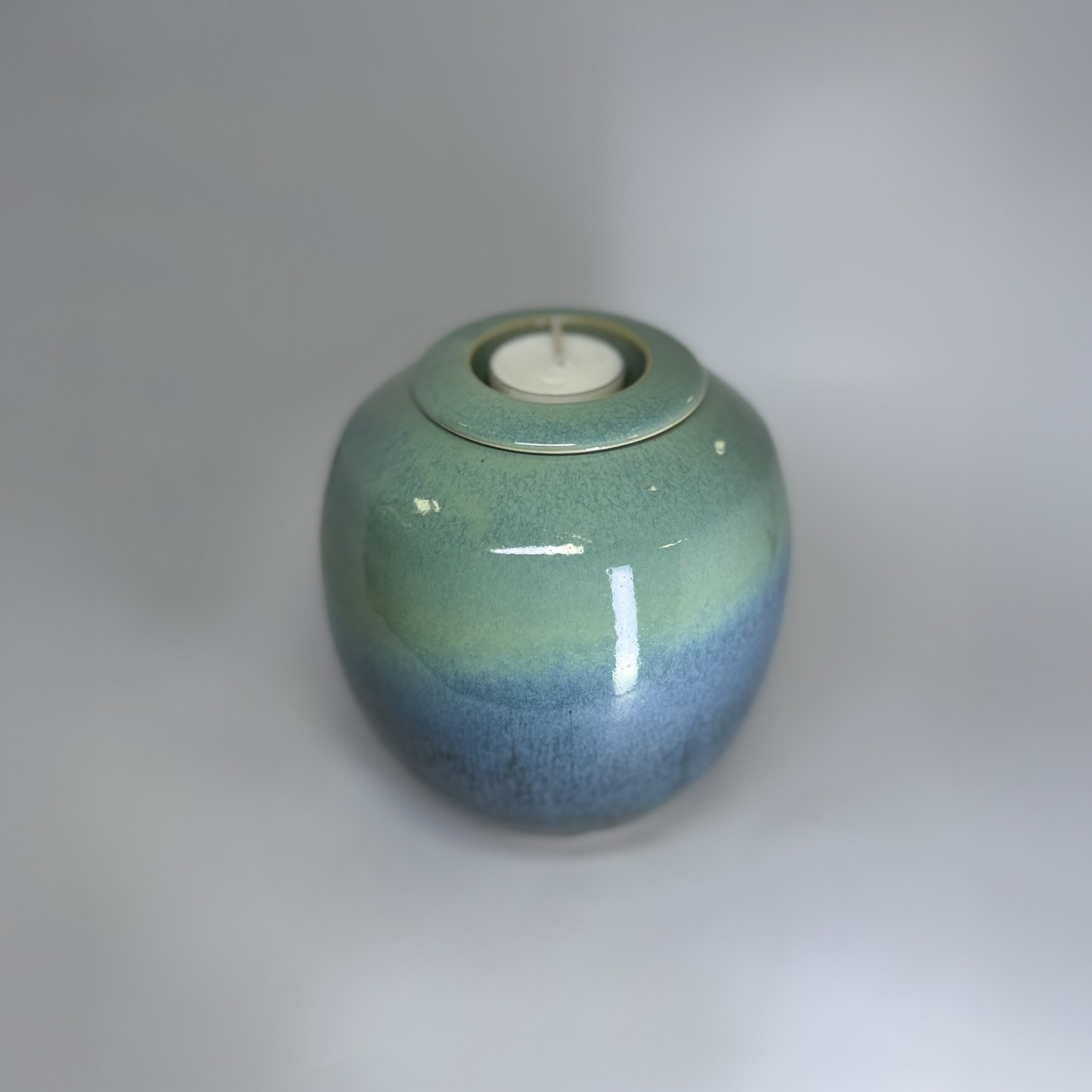 Seafern ceramic urn with fitted tealight candle holder showing gentle color transition