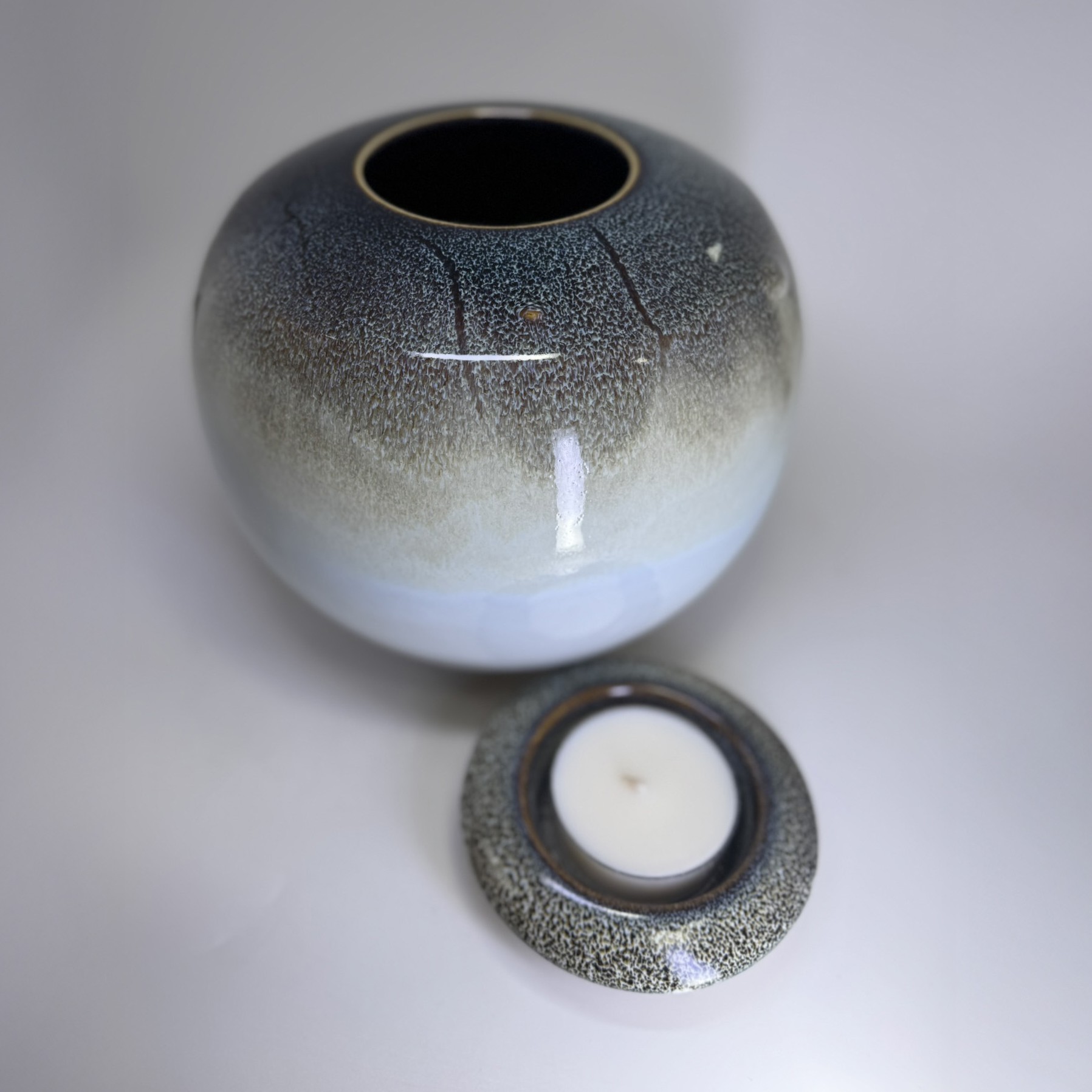 Solstice memorial urn with removable candle holder lid shown separately in matching glaze